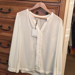 Cream color white tunic type blouse.