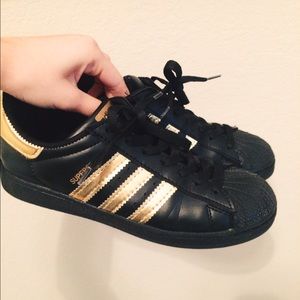 Adidas black & gold superstar sneakers