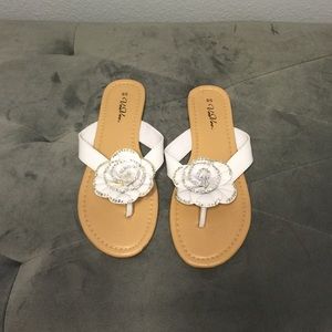 White and silver rosette flip flops