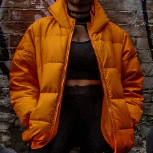 Orange puffer coat by Benetton