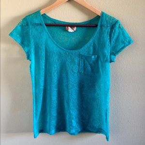 Turquoise shirt with little holes.