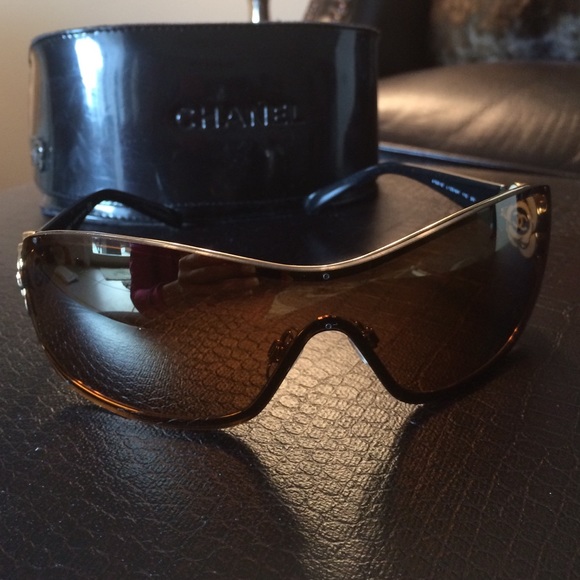 Chanel Gold rimmed sunglasses. Black arms