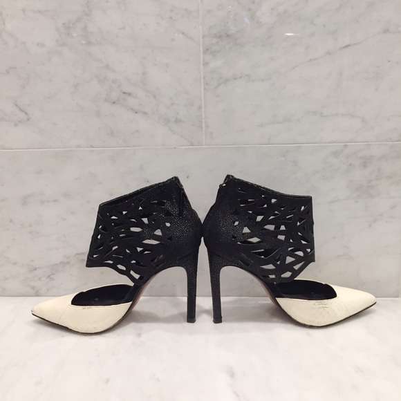 Black and white perforated Dolce Vita pumps.
