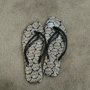 Cute flip flops with rose print design.