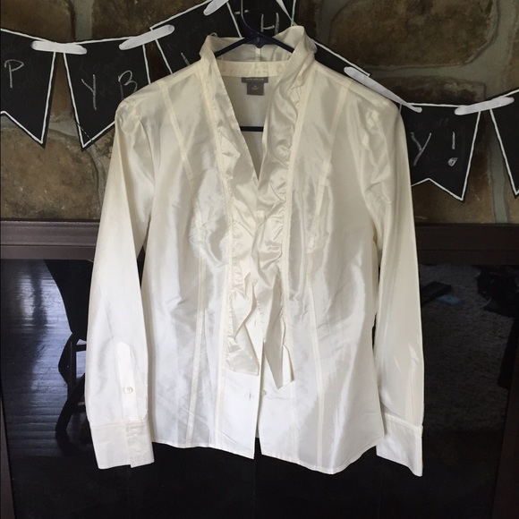 Beautiful creamy silk blouse with ruffle accent.