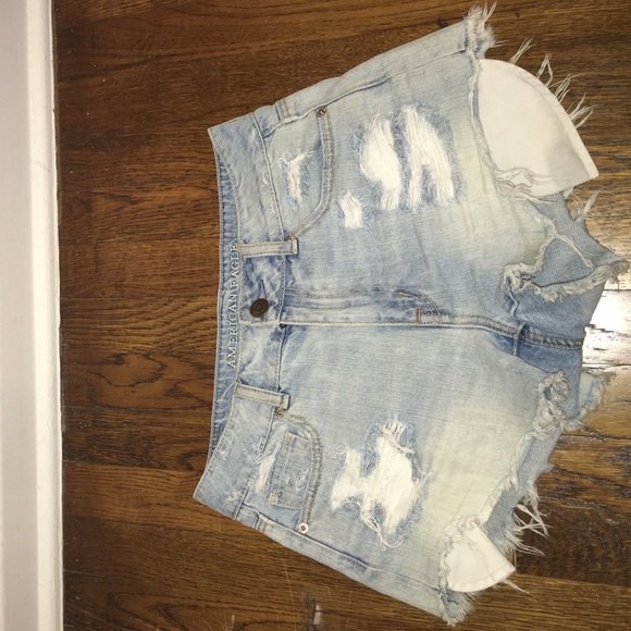 Distressed high waisted blue jean shorts.