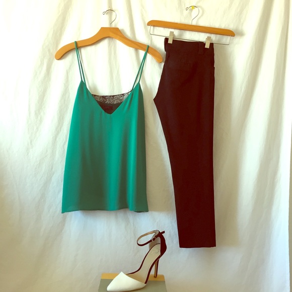 Green silk camisole with black lace detail.