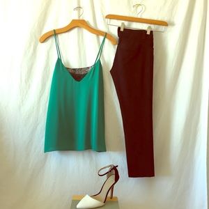 Green silk camisole with black lace detail.