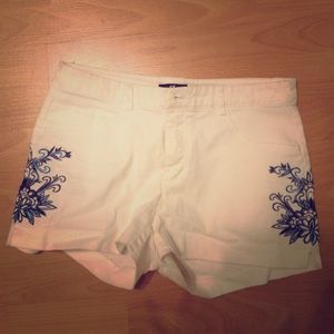 White shorts with blue stitching on sides