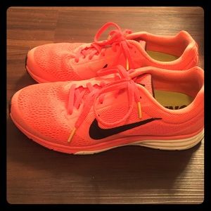Bright peach/pink Nike running shoes
