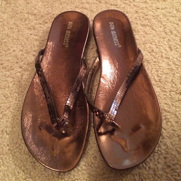 Never been worn! Bronze flipflops.