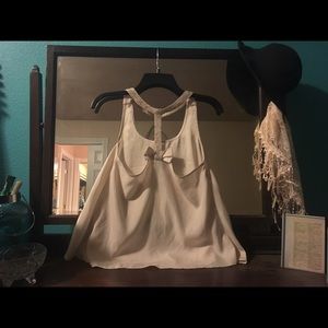 Cream tank with beaded straps and bow in the back.