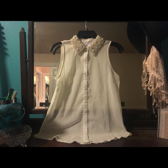 Cream sleeveless tank with pearl beaded collar.