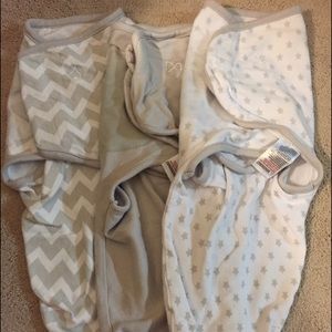 Three small Swaddle Me sleep sacks
