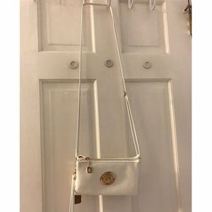 White cross body with gold emblem