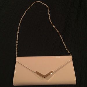Nude color purse with gold straps that come off
