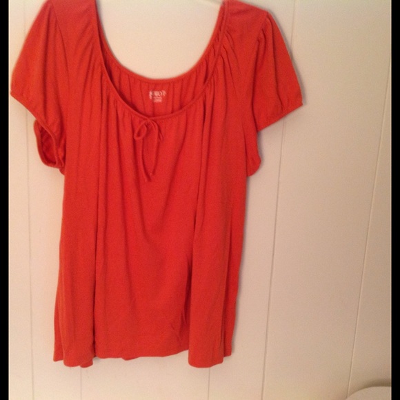Orange short sleeve blouse.