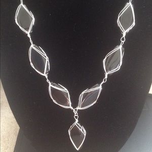 Glass beads, intertwined in silver colored metal