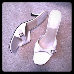 White slide heel with silver buckle, leather upper