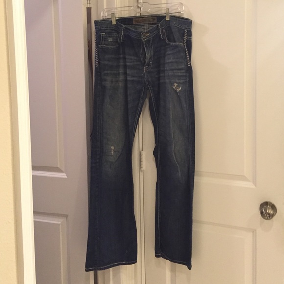 Men's distressed dress blue jeans
