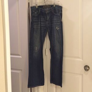 Men's distressed dress blue jeans
