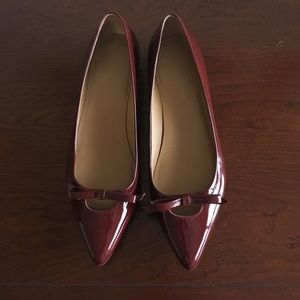 Patent red leather shoes with modern bow.