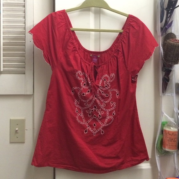 Red blouse with detail embroidery and cut outs.
