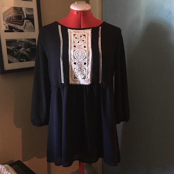 Black top with crocheted detailing. NWT