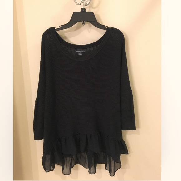 Black knit high low sweater with ruffle detailing