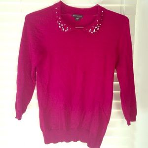 Raspberry red cardigan with neck embellishment.