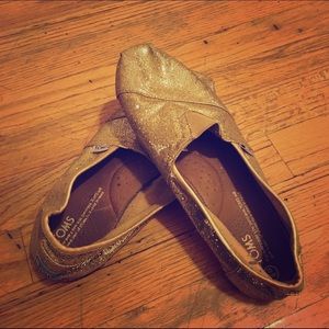 Gold glitter TOMS shoes