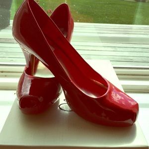 Brand new red patent pumps. Never worn. Size 7.5