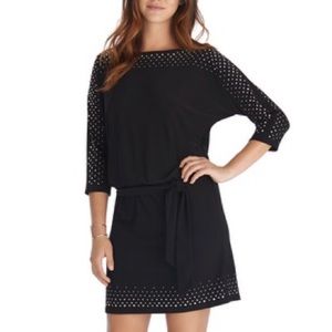 Black dress with studs on collar, sleeves, bottom.