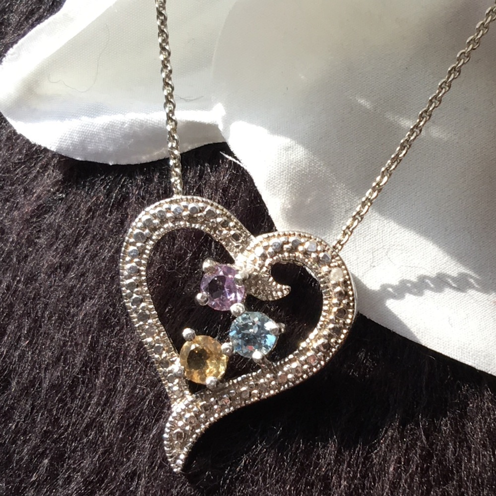 A Heart necklace with beautiful colored stones.