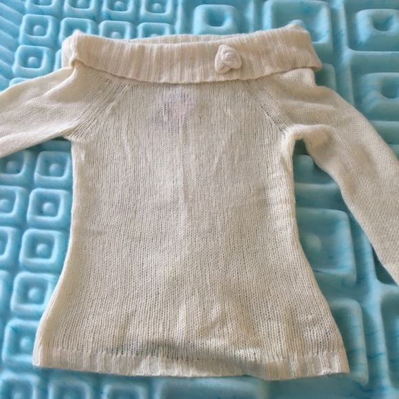 Large white sweater with flower pin on collar