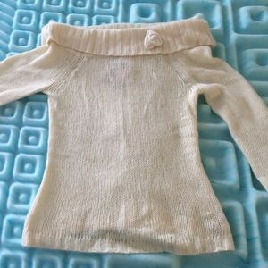 Large white sweater with flower pin on collar