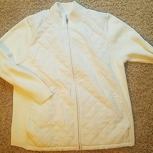 White sweater or jacket with quilted front.
