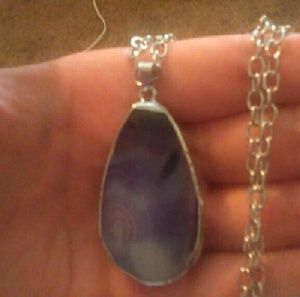 Purple stone with gold trim around it
