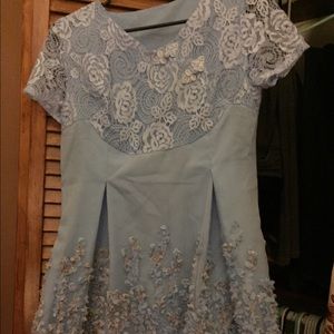 Light blue dress with embroidered flowers.