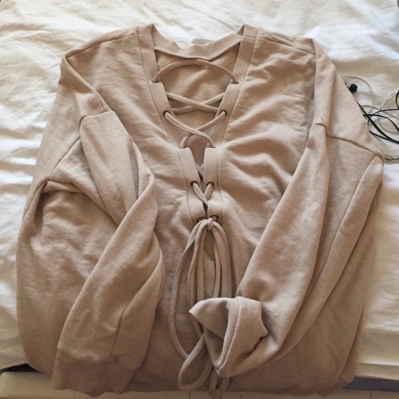 long beige sweater with cross on front
