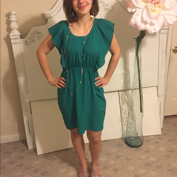 Bold ruffled green knee length dress.