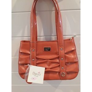NWT. Beijo Purse. Color is orange