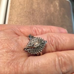 Glistening, diamond cluster ring in marquis shape.