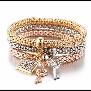 Tri colored bracelet with lock and key