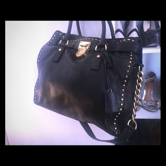 Michael Kors black leather bag with gold accents.