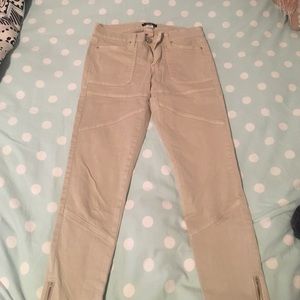 Beige skinny pants with zippers at the ankles