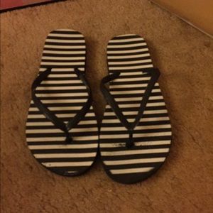 Black and white striped flip-flops