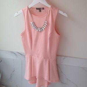 Pink peplum top with necklace