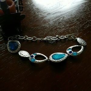 Silver necklace with blue crystals.