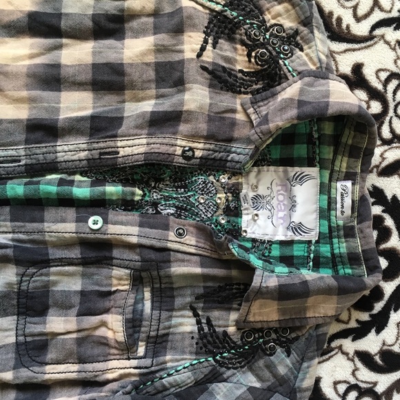 Plaid shirt, sleeves roll up.